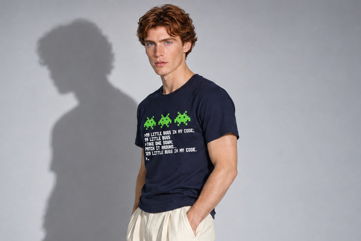 A developer in a navy 99 Little Bugs In The Code t-shirt